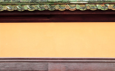 Stucco wall of traditional japanese house with oriental decorative roof tile