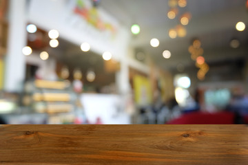 Empty dark wooden table in front of abstract blurred bokeh background of restaurant . can be used for display or montage your products.Mock up for space.