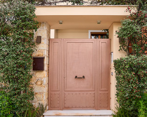 Fototapeta na wymiar contemprary house entrance metalic brown door, Athens wealthy northern suburbs, Greece