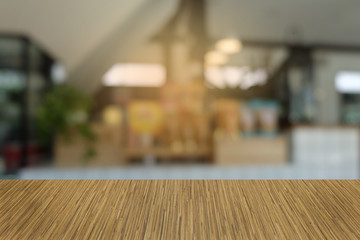 Empty dark wooden table in front of abstract blurred bokeh background of restaurant . can be used for display or montage your products.Mock up for space.