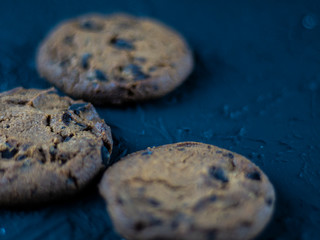 Chocolate chip cookies on a dark stone background