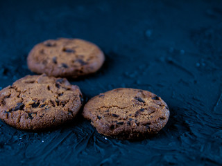 Chocolate chip cookies on a dark stone background