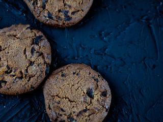 Chocolate chip cookies on a dark stone background