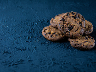 Chocolate chip cookies on a dark stone background