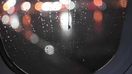 Dripping rain on airplane window before takeoff.  A good symbol of tears, sadness