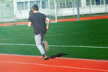 Fototapeta premium Sport man running on a racetrack