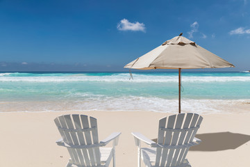 Umbrella and chairs on vacation tropical beach. Summer vacation and tropical beach concept.  