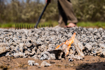 Men's feet with blue socks and campfire rests. Hiking, campground concept.