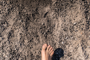 Men's feet with blue socks and campfire rests. Hiking, campground concept.