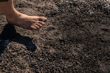Men's feet with blue socks and campfire rests. Hiking, campground concept.