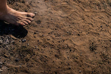 Men's feet with blue socks and campfire rests. Hiking, campground concept.