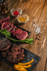 meat, mint, grilled burgers, on a wooden table.