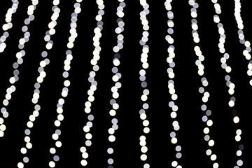 Abstract bokeh of white lights on black background. defocused and blurred many round light