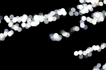 Abstract bokeh of white lights on black background. defocused and blurred many round light