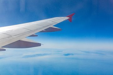 Wing of an airplane. Traveling concept. Aircraft wing on the clouds
