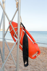 Beach life-saving. lifeguard tower with orange buoy on the beach. rescue buoy on the iron rescue post