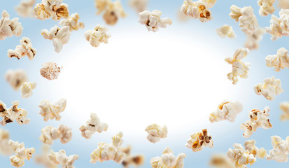 Popcorn frame, flying popcorn isolated on white background with copy space, movie poster concept - obrazy, fototapety, plakaty