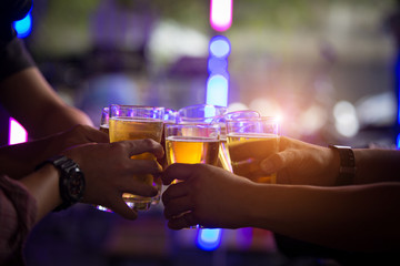 Group of  young people hands toasting and cheering aperitif beers half pint
