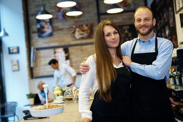 Waiter and waitress in apron