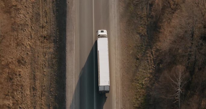 Truck driving / traveling on highway aerial footage at spring time / top view / Highway truck traffic