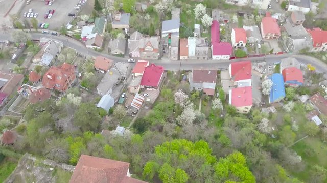 Drone Aerial Pull Up Shot of Uzhhorod Ukraine Cityscape from Castle on Spring Day