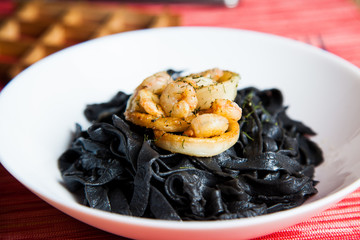 Homemade black noodles (squid ink) with schrimps