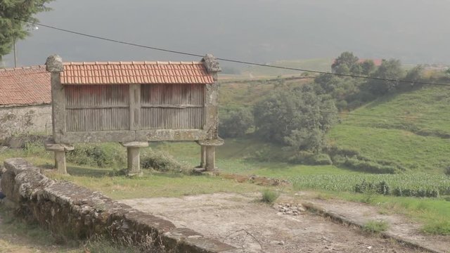 Rack focus on a granary called espigueiro in a rural village on a hill Friaes Tras-os-Montes Portugal