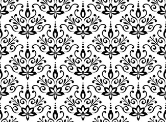 Floral pattern. Vintage wallpaper in the Baroque style. Seamless vector background. White and black ornament for fabric, wallpaper, packaging. Ornate Damask flower ornament