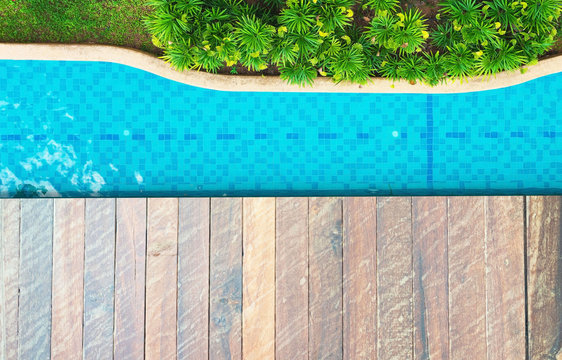 top view Beautiful blue water ,swimming pool for background and wood floor .Blank space for text and images.