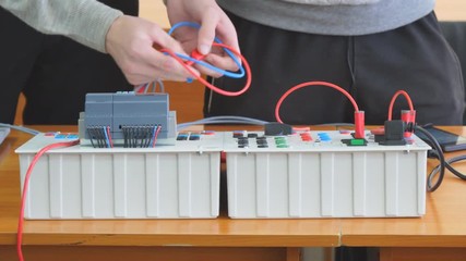 Engineers connect wires control panel or Electrical training device