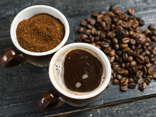 Whole roasted coffee, freshly ground coffee and brewed fragrant espresso in a Cup