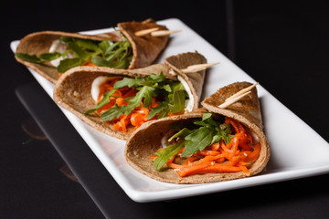 liver pancakes rolls on a dark background