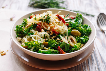 Pasta with olive, cabbage and nuts. Italian dish.