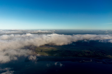 Flying above the clouds, view from the airplane, New Zealand