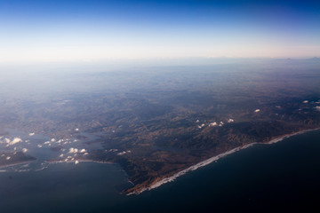 Flying above the clouds, view from the airplane, North Island, New Zealand