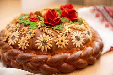Bread lies on embroidery. Loaf wedding cake