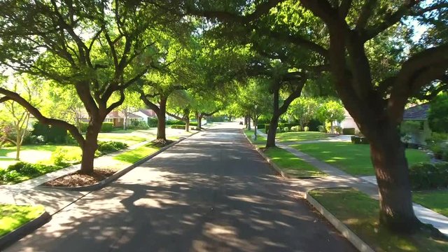 Aerial drone footage going down a Pasadena street during a sunny afternoon