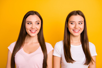 Close up photo two people beautiful funky funny she her ladies look side silly childish mod know tell speak talk listen rumours chatterbox wear white pink casual t-shirts isolated yellow background