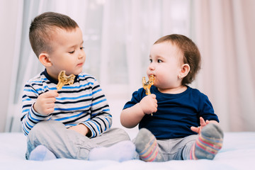Brother and sister eat lollipops in the form of a cock