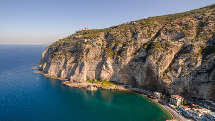 Fototapeta premium Aerial View of the Sorrento coast. Meta beach, travel concept, space for text, bay with boats, Italia mountains, travel concept