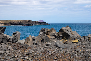Fototapeta na wymiar View at the ocean with the volcanic rocks and faraway island, Tenerife, Canary Islands, Spain - Image