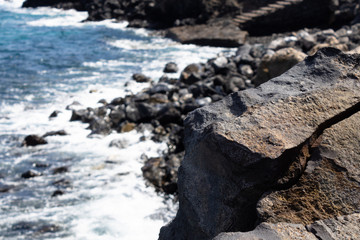 Volcanic rock close up with the rocky beach on the background, Tenerife, Canary islands, Spain - Image