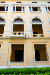 the beautiful yellow building ,Vintage building and many black window . 