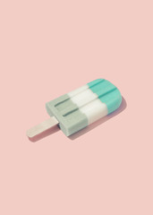 Colorful Ice cream popsicle on pastel pink background. Minimal summer concept. Flat lay.