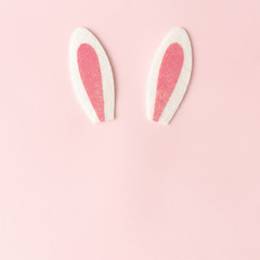 Bunny rabbit ears on pastel pink background. Happy Easter minimal concept. Flat lay.