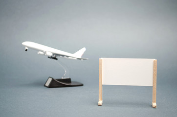 A poster with a place for text and a plane. Concept travel around the world. Hot tours. Rest. Summer vacation. Available discounts. Minimalism. Copy space. Traveling.