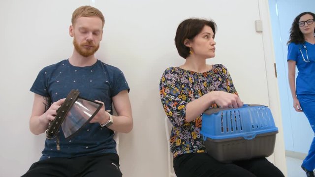 Young couple sitting n vet office