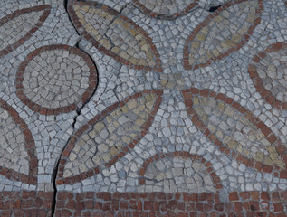 Fototapeta na wymiar Elements of an ancient ceramic mosaic on the stone
