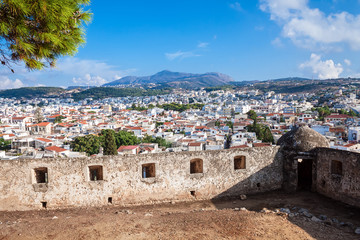 Rethymnon, Crete, Greece - August 15, 2015: view from the fortress of Fortezza to the city of Rethymnon. Roofs of houses and mountains