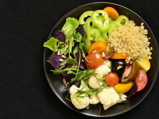 Vegetarian salad with quinoa, vegetables and sunflower seeds. Buddha bowl, top view, copy space